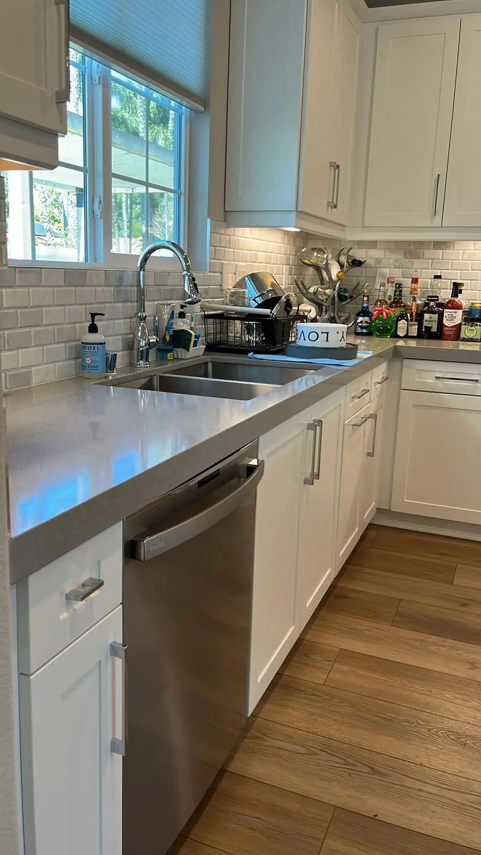Clean kitchen sink, countertop, and backsplash after detailed house cleaning service